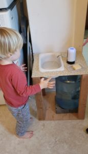 Toddler using sink